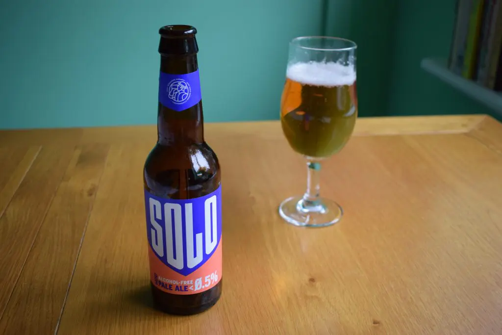 Bottle of WBB Solo non-alcoholic beer with glass