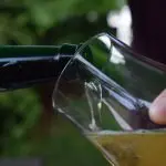 Close up of a person pouring a non-alcoholic beer
