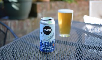 Toast Lemongrass Lager can with glass in background